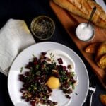 A plate of beet tartare with mango yolk and crostini.