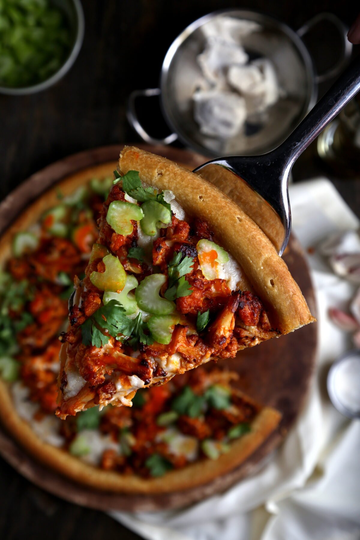 A buffalo cauliflower pizza with vegan mozzarella and celery.