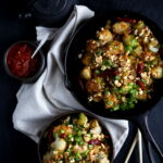 Crispy Kung Pao Brussels Sprouts in a cast iron pan.