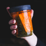 Carrots and dill in a jar of brine.
