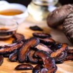 Shiitake bacon, a vegan bacon alternative, on a cutting board.