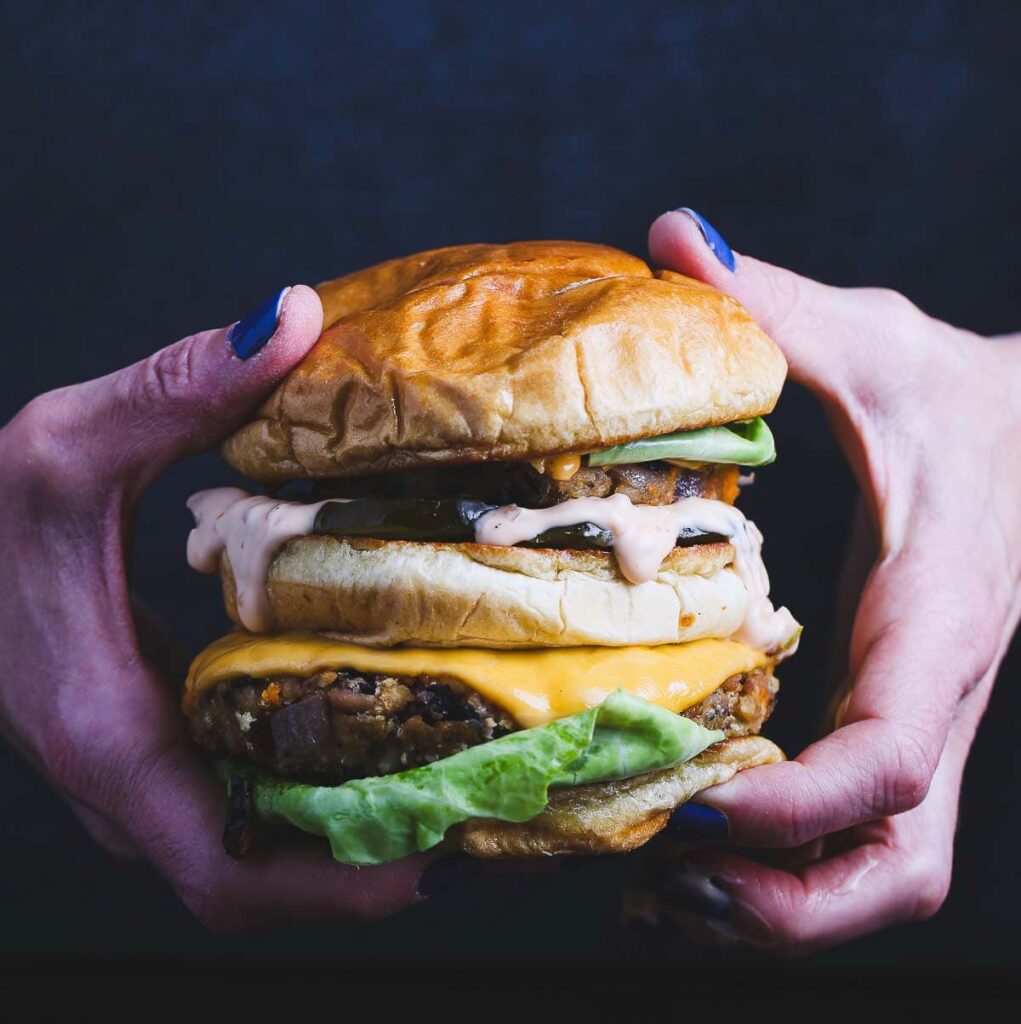 A handheld black bean and sweet potato veggie burger.