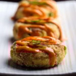 A row of vegan crab cakes on a plate.