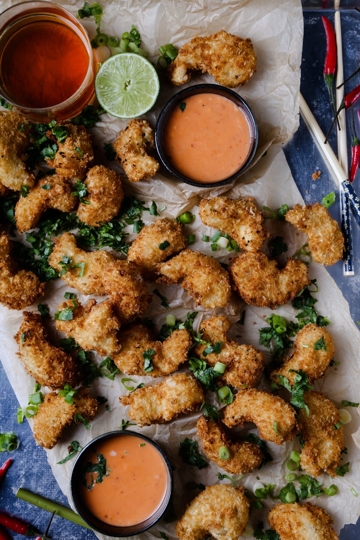 A top down shot of breaded vegan shrimp with sauce.